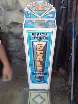 Coin operated weight scale.