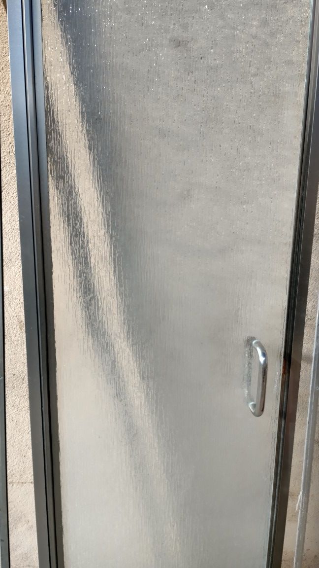 Frameless tempered glass shower door.