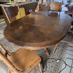Solid Wood Antique  Table W/ 4 Chairs.Has Extra Piece To extend table.Three toed  claw  foot legs.