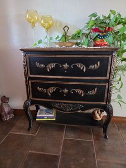 Black and golden entry accent table with beautiful curved legs 2 drawers and lower shelf.