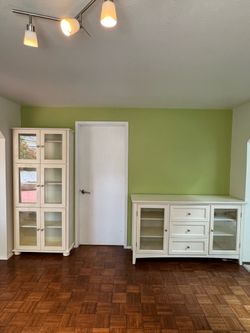 White wooden kitchen buffet  and tall glass cabinet