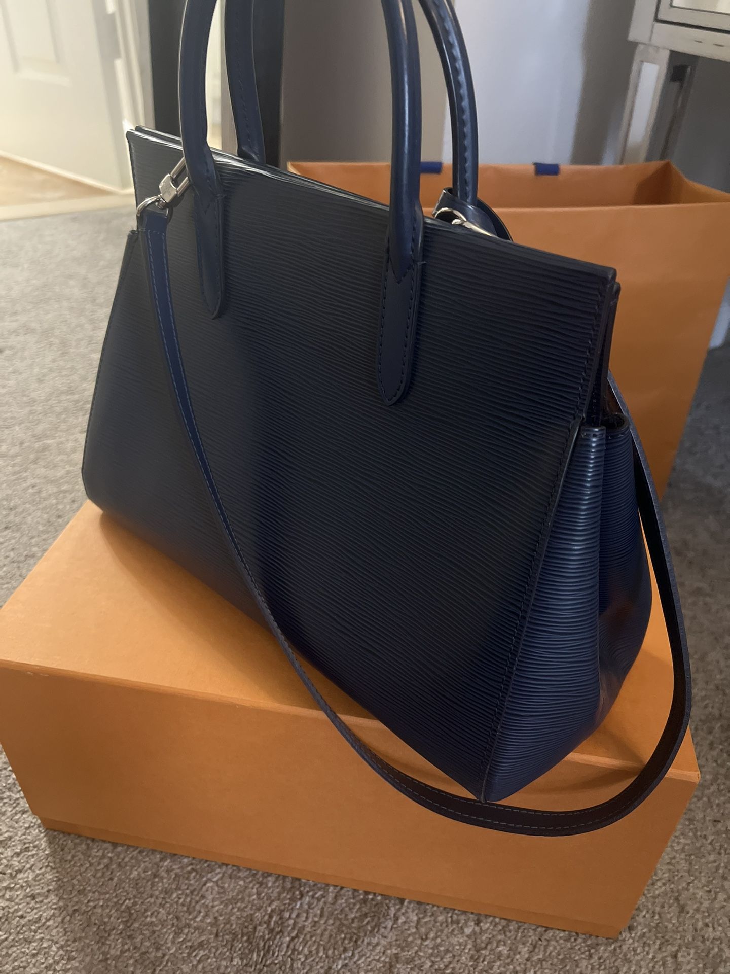 The Louis Vuitton Indigo Epi Leather Marly MM bag is a dark blue