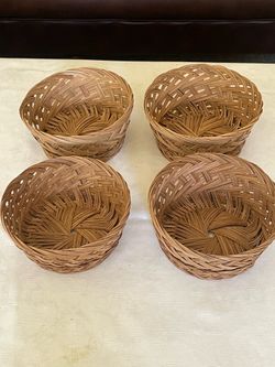 Set of four vintage woven wicker decorative baskets.