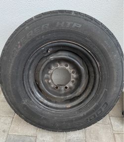 A Cooper Discoverer HTP light truck tire mounted on a 16-inch black steel wheel with an 8-lug bolt pattern.