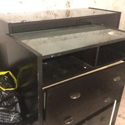 2 charcoal black dressers with 2 individual cubbies on the interior of the dresser