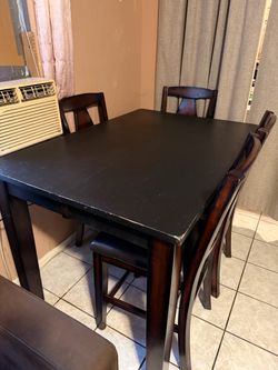 Solid wood expandable dining table w/ 4 chairs.