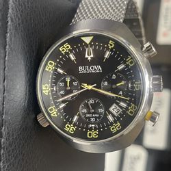 This is a Bulova Accutron II Lobster Chronograph watch with a black dial and a stainless steel mesh bracelet