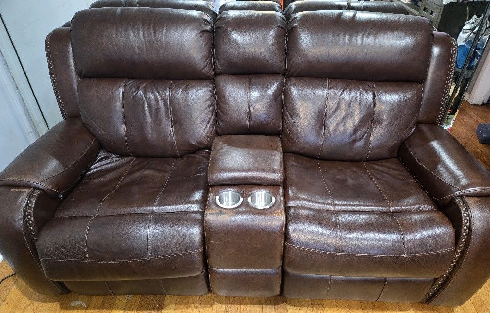 Used 100% Grain Power Leather Reclining Sofa and Loveseat with Console and Charging Ports.