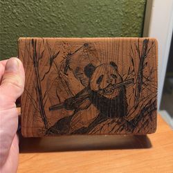 Wood burning art of panda eating bamboo