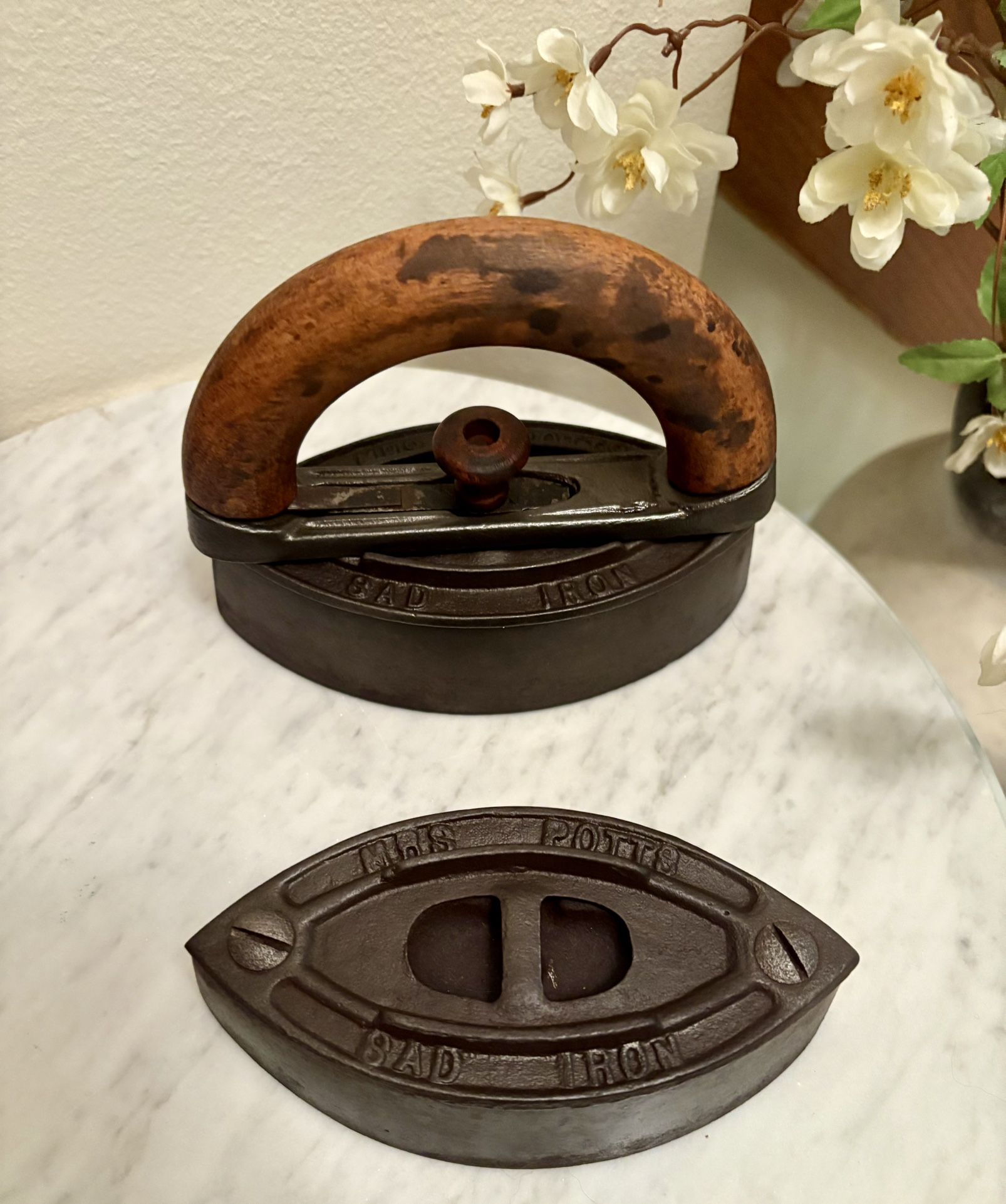 A Pair of Antique Cast Iron Mrs. Potts Sad Irons with Interchangeable Handle