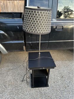 Bedside table with lamp and chargers