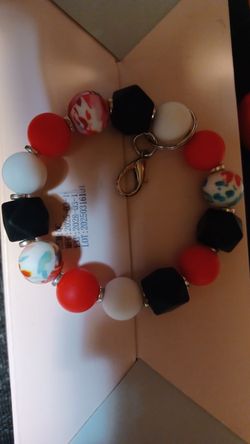 handmade, decorative bead pens and wristlet keychains with Care Bears-themed toppers.
