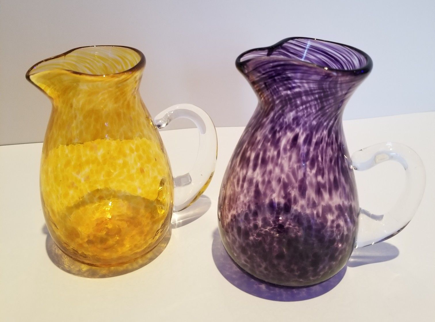 Handblown Ron Hinkle Glass Pitchers Set Of 2. Yellow Is Signed By Artist 2009, Purple Is Signed By Artist 2012
