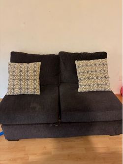 2 seater black couch with 2 pillows