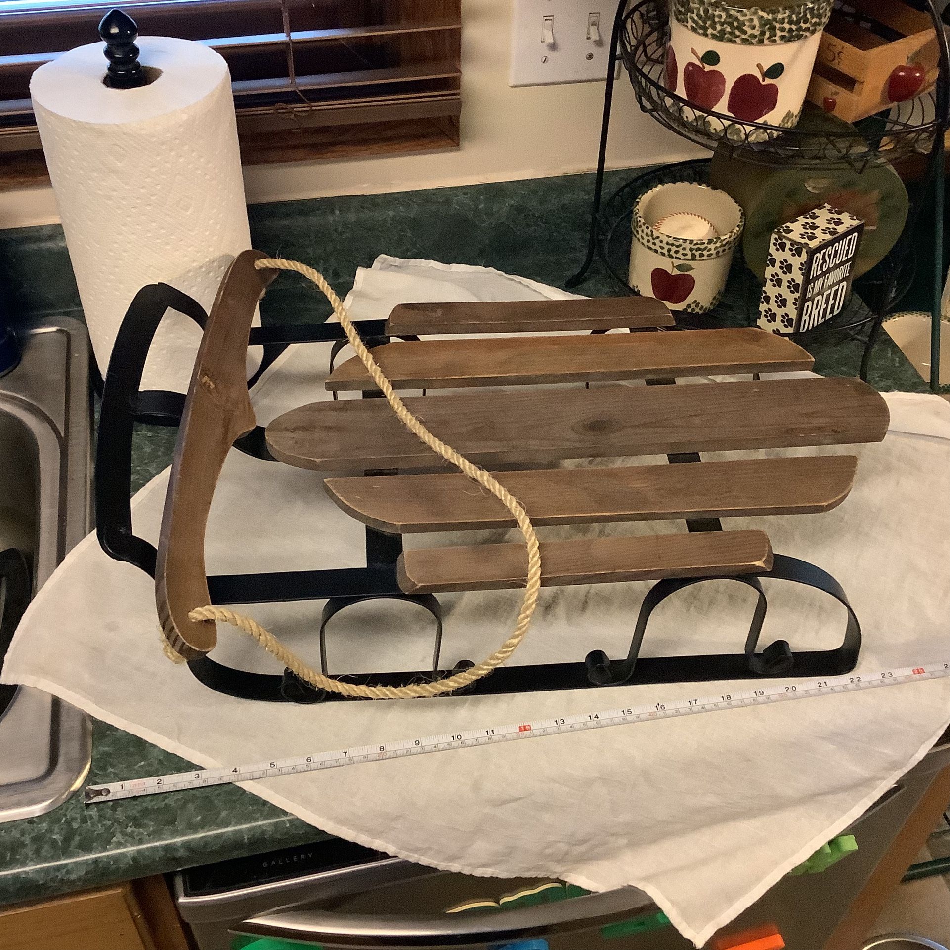 Wooden sled in great condition. Approximately 22” long and 12” wide has rope to steer or to hang as decoration. Metal base no rust never used outdoors