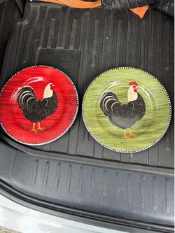 Vintage plates with rooster pictures on it