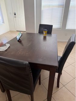 Dark wooden table with four chairs