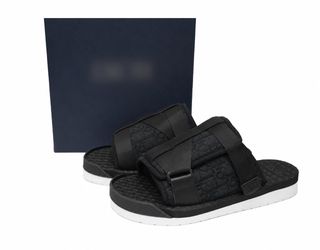 Black D..I..O..R slides with textured woven pattern