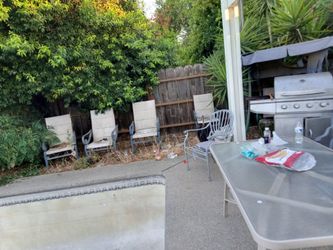 Patio furniture includes table and four chairs and extra