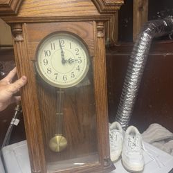 Clocks One Is A Grandfather Wall Clock And The Other Is A Collectible Disney Wall Clock 