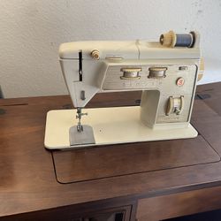 Singer golden touch and sew deluxe zig-zag model 750 with wood cabinet. Comes with the original manual and accessories. Works but needs cleaning and a