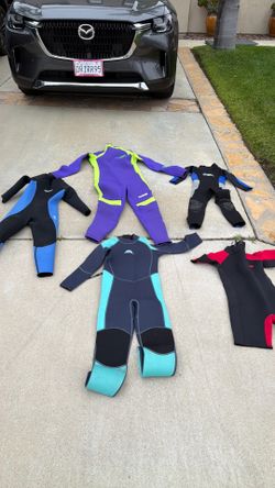 Collection of kids wetsuits various sizes for sale all in good condition