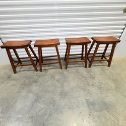 4 counter hight stools backless wood saddle seats 24”  sturdy solid oak finish great condition