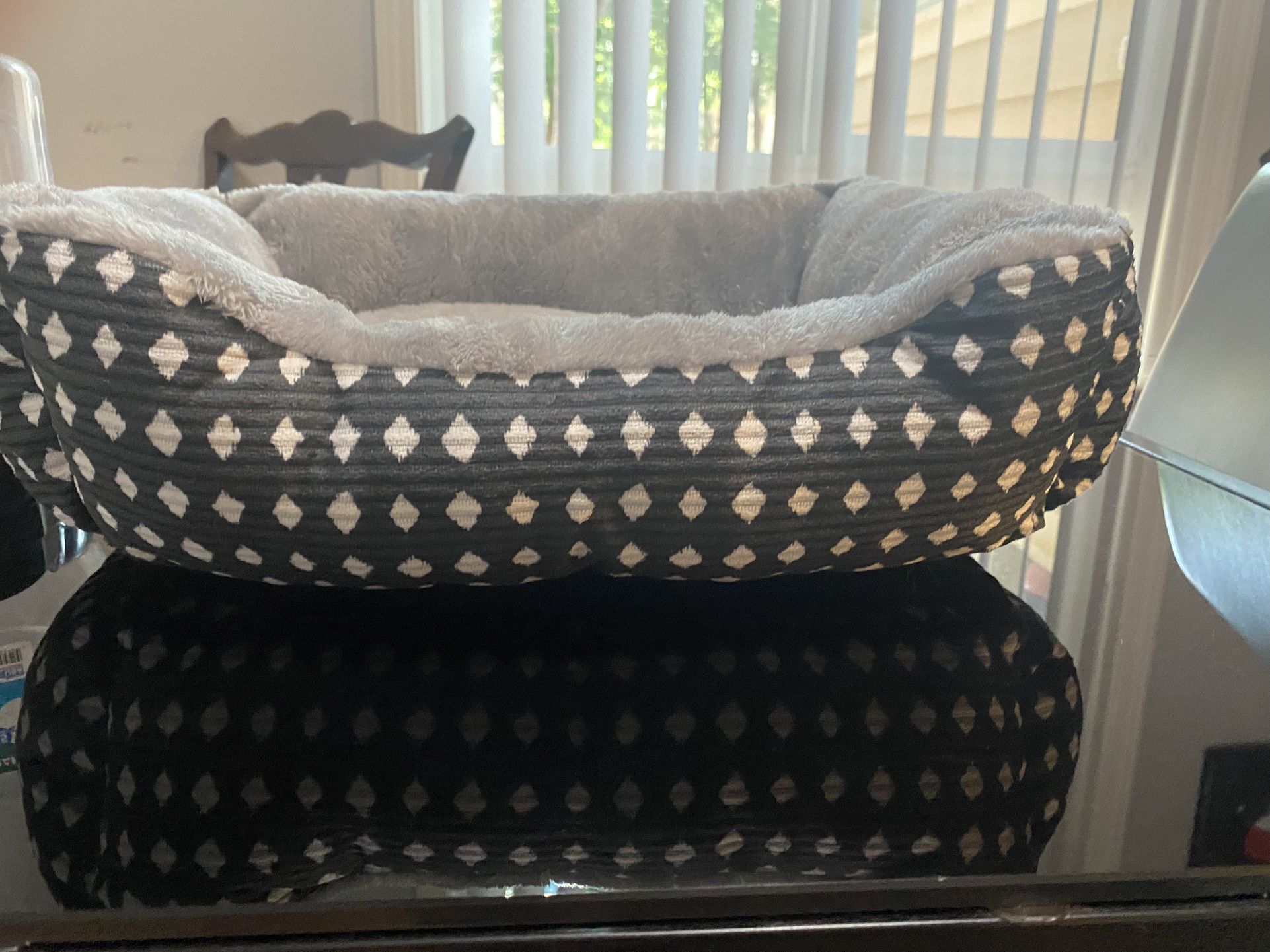 A small bed for the pet and a plastic for drinking water