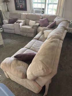 3 piece sectional with 4 manual recliners, storage with cup holders built in.