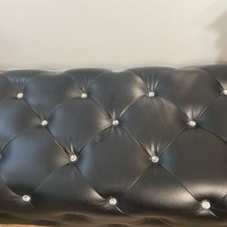 Black faux, leather upholstered ottoman