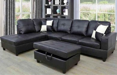 Black leather sectional couch and ottoman