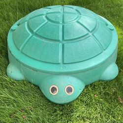 Little Tikes Green Turtle Lidded Sandbox – used outside