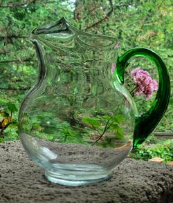Vintage Libbey Acapulco clear glass pitcher featuring a vibrant green handle and an ice guard spout