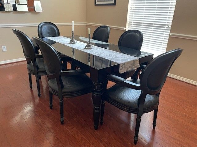Modern baroque black lacquer dining-room table with crocodile pattern chairs