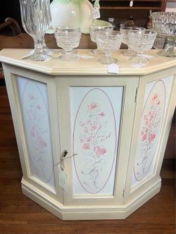 Cream and white cabinet with pink floral design and good storage