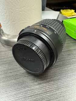 Nikon AF-S DX Zoom-Nikkor 55-200mm f/4-5.6G ED lens, which includes a Merkury Optics UV filter attached to the front.