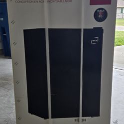 Small refrigerator, new in its box, never used.