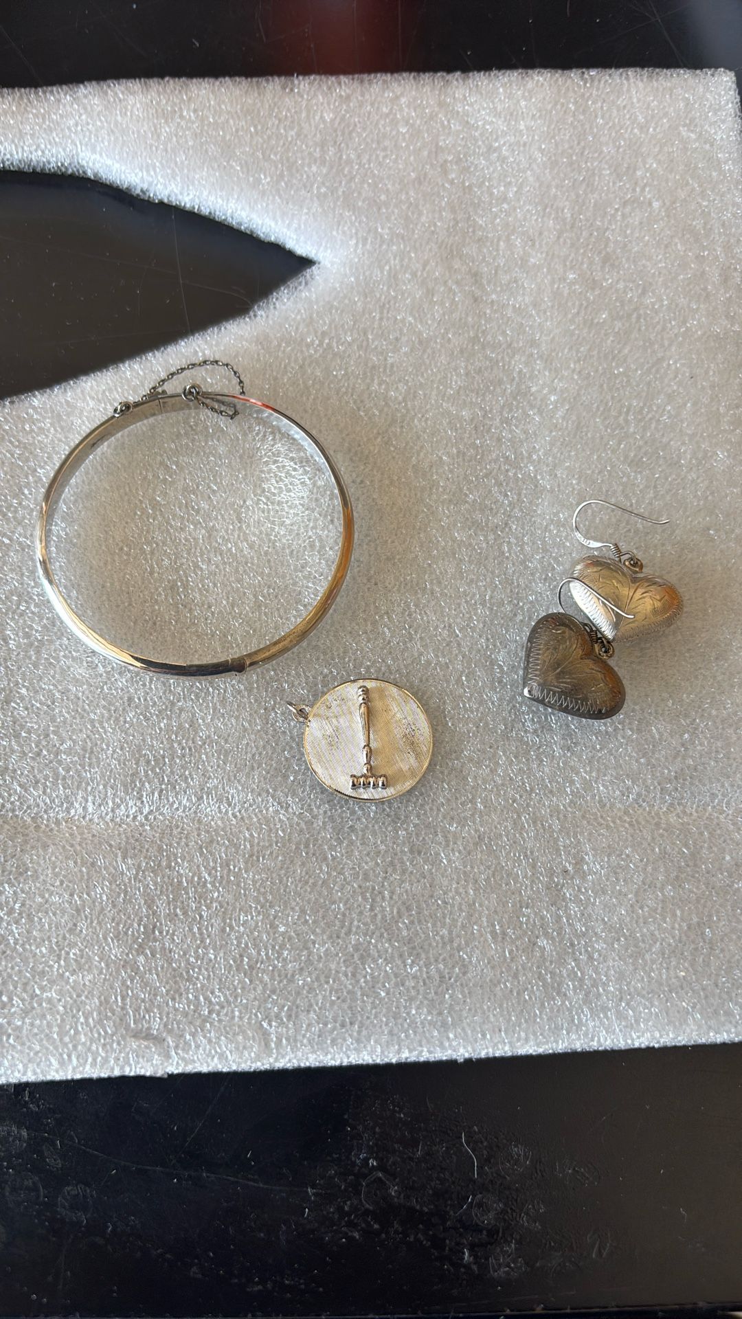 Silver Bracelet, Earrings, And Charm