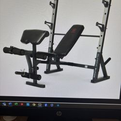 Olympic surge weight bench with weights and 7 Foot Barbell