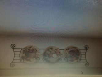 A clock, 3 plates with the plate holder and 2 candle holders.