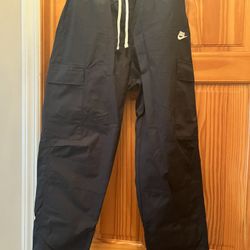 Nike men’s cargo pants. Color black. Size medium. Length from top to bottom is 40 inches. Lots of pockets