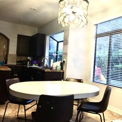 White dining table with 4 vegan leather chairs