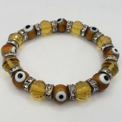Evil Eye Yellow Tone Glass  Bracelet.  6.5" Stretch. Excellent Condition. 