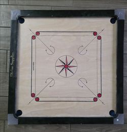 Carrom board, coins, striker, and powder