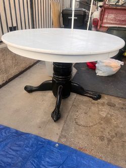 Round wood table with pedestal base