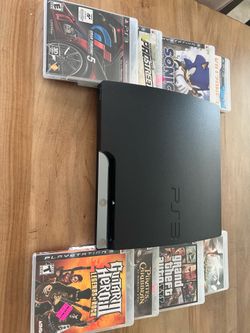 PS3 console with games and controllers