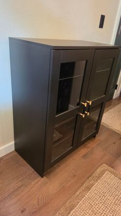 Black Cabinet with Glass Doors and Gold Handles