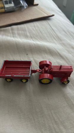vintage Tootsietoy farm tractor and utility cart set from the 1960s or 1970s.