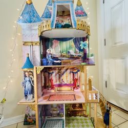 Disney Princess Royal Celebration wooden doll house made by KidKraft. It stands over five feet tall. (4) four Frozen Disney Princess Dolls