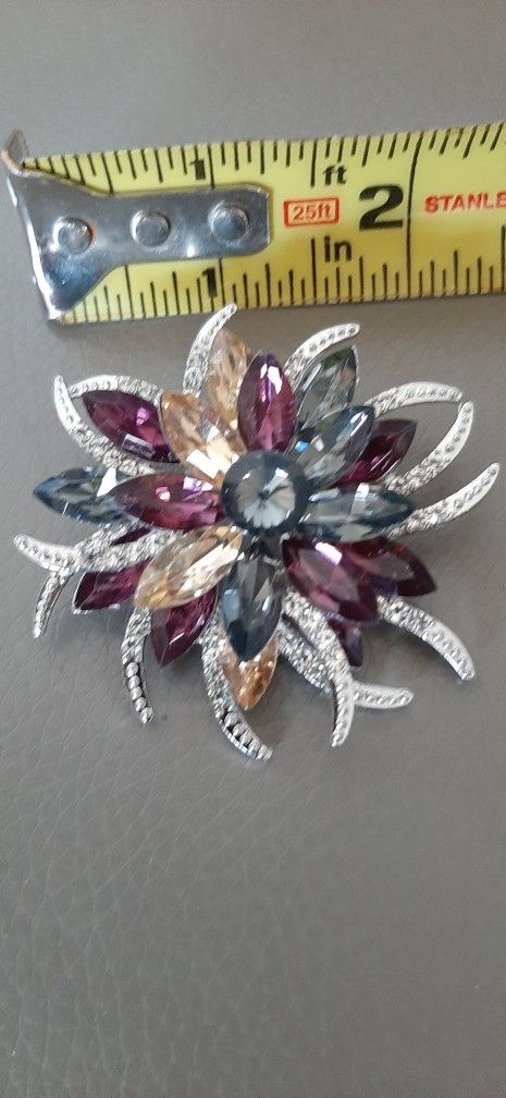 Brooch with multicolor gemstones & silver accents.